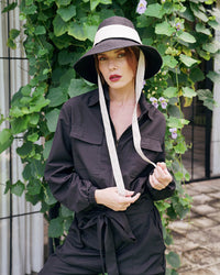 Our cool and casual Amelia Jumpsuit in black with its relaxed style is designed for the perfect traveling or outdoor occasion. Complete with a spread collar, tie waist, and front utility pockets, this chic jumpsuit offers a simple yet stylish look.