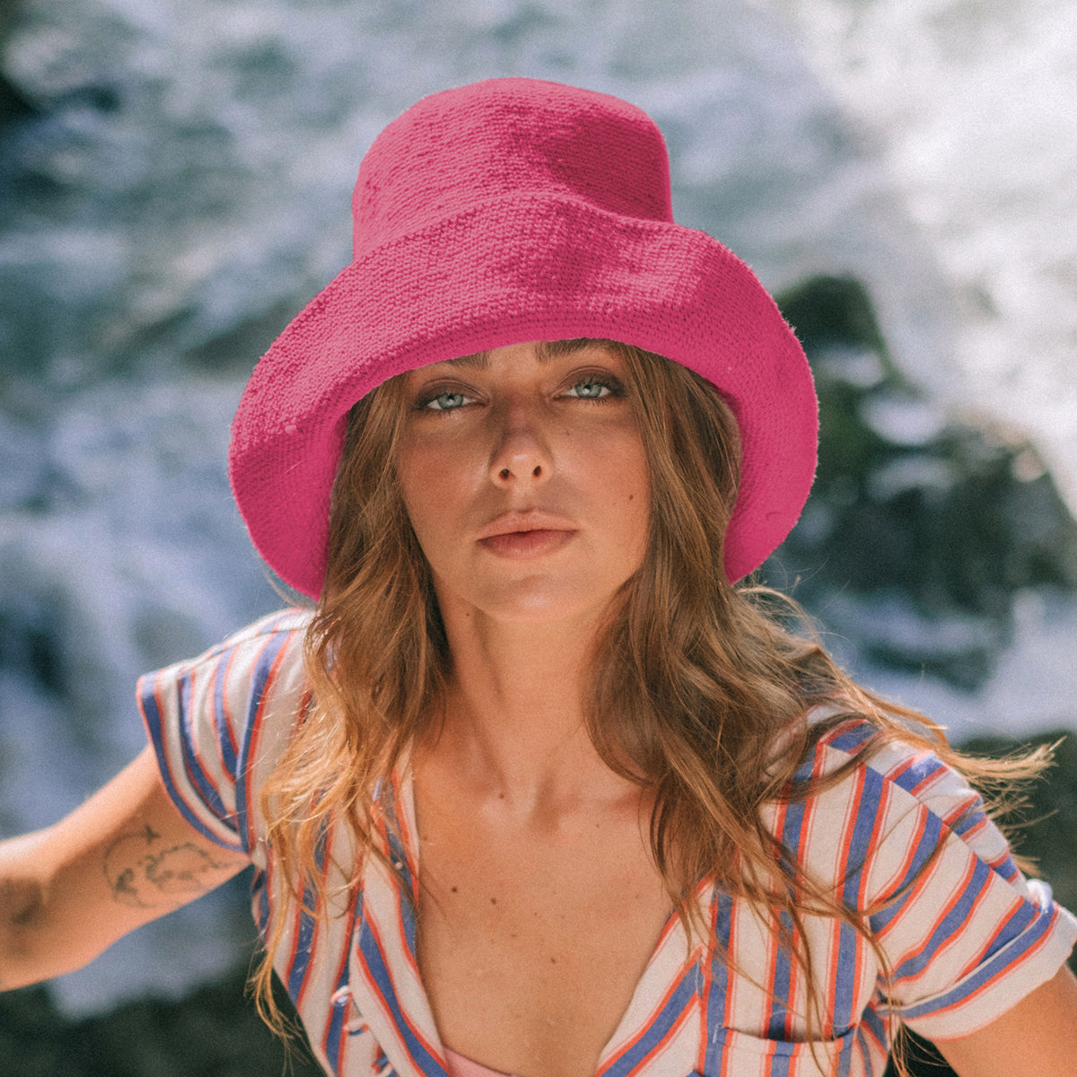Bloom Crochet Cotton hat in Hot Barbie Pink. Soft and shapeable crochet hat inspired by the classic Calla Lily flower shape. Meticulously made by artisans in the villages of Bali. Its light and semi-floppy construction make it the perfect hat for picnics at the beach or any outdoor hike sessions any season of the year.