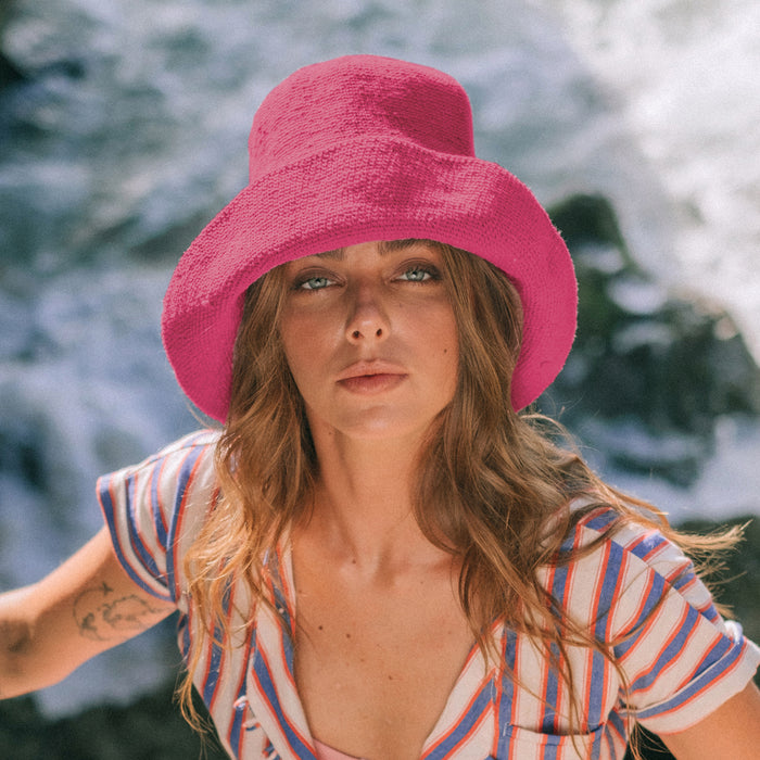 Bloom Crochet Cotton hat in Hot Barbie Pink. Soft and shapeable crochet hat inspired by the classic Calla Lily flower shape. Meticulously made by artisans in the villages of Bali. Its light and semi-floppy construction make it the perfect hat for picnics at the beach or any outdoor hike sessions any season of the year.