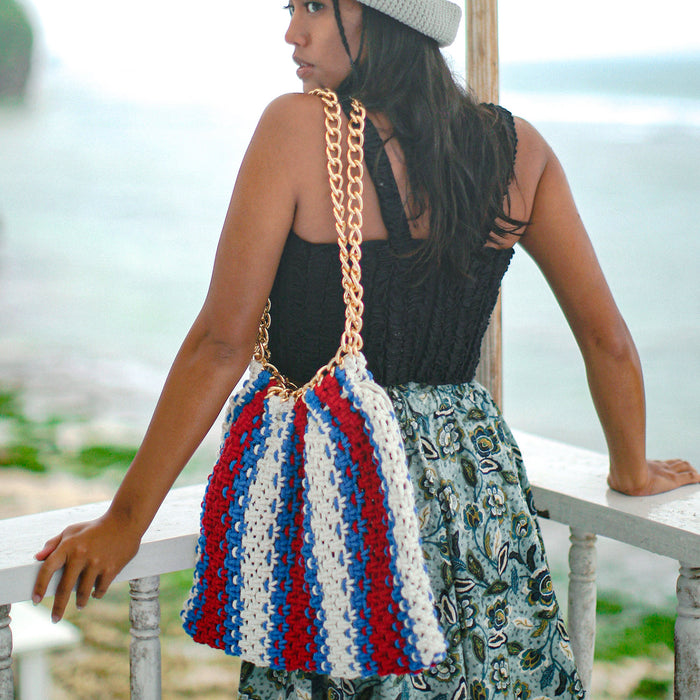 Colette Macrame Beach Tote in Red White and Blue. Ideal for beach holidays, COLETTE has been hand-woven from a durable cotton rope with flattering chain straps and tasseled ties. It’s just the perfect to store all your beach essentials for a care-free island getaway. Wear yours with matching separates for an effortless beach look.