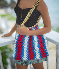 Colette Macrame Beach Tote in Red White and Blue. Ideal for beach holidays, COLETTE has been hand-woven from a durable cotton rope with flattering chain straps and tasseled ties. It’s just the perfect to store all your beach essentials for a care-free island getaway. Wear yours with matching separates for an effortless beach look.