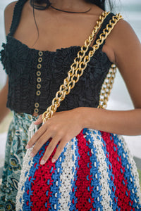 Colette Macrame Beach Tote in Red White and Blue. Ideal for beach holidays, COLETTE has been hand-woven from a durable cotton rope with flattering chain straps and tasseled ties. It’s just the perfect to store all your beach essentials for a care-free island getaway. Wear yours with matching separates for an effortless beach look.