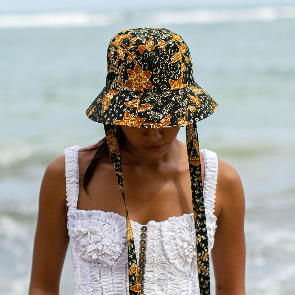 The Jasmine hat in Black and brown  is made meticulously of handpainted Batik fabric into a bucket silhouette with a medium dome-down brim to keep you under the shade during summer’s hottest days.  Made with light yet structural shape, the Jasmine hat is made to be your summer vacation essential. &nbsp;It has a packable design that makes it perfect for travel or storing in your beach bag.