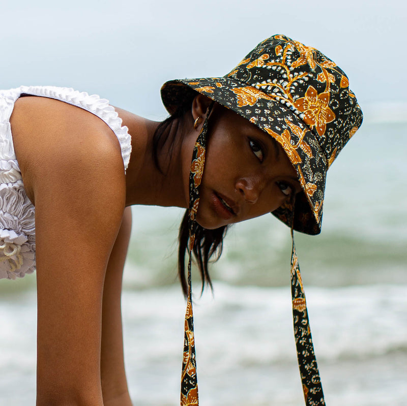 The Jasmine hat in Black and brown  is made meticulously of handpainted Batik fabric into a bucket silhouette with a medium dome-down brim to keep you under the shade during summer’s hottest days.  Made with light yet structural shape, the Jasmine hat is made to be your summer vacation essential. &nbsp;It has a packable design that makes it perfect for travel or storing in your beach bag.