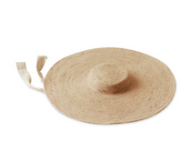 Lola Wide Brim Jute Straw Hat In Natural Beige. This sun hat is hand-weaved meticulously by women artisans in Gianyar, Bali from natural Jute material, this sweet hat offers both comfort and elegance. Designed with ideal thickness and weight that allow its brim to be easily folded, stretched, and styled, making it easy to take to any holiday trip. 