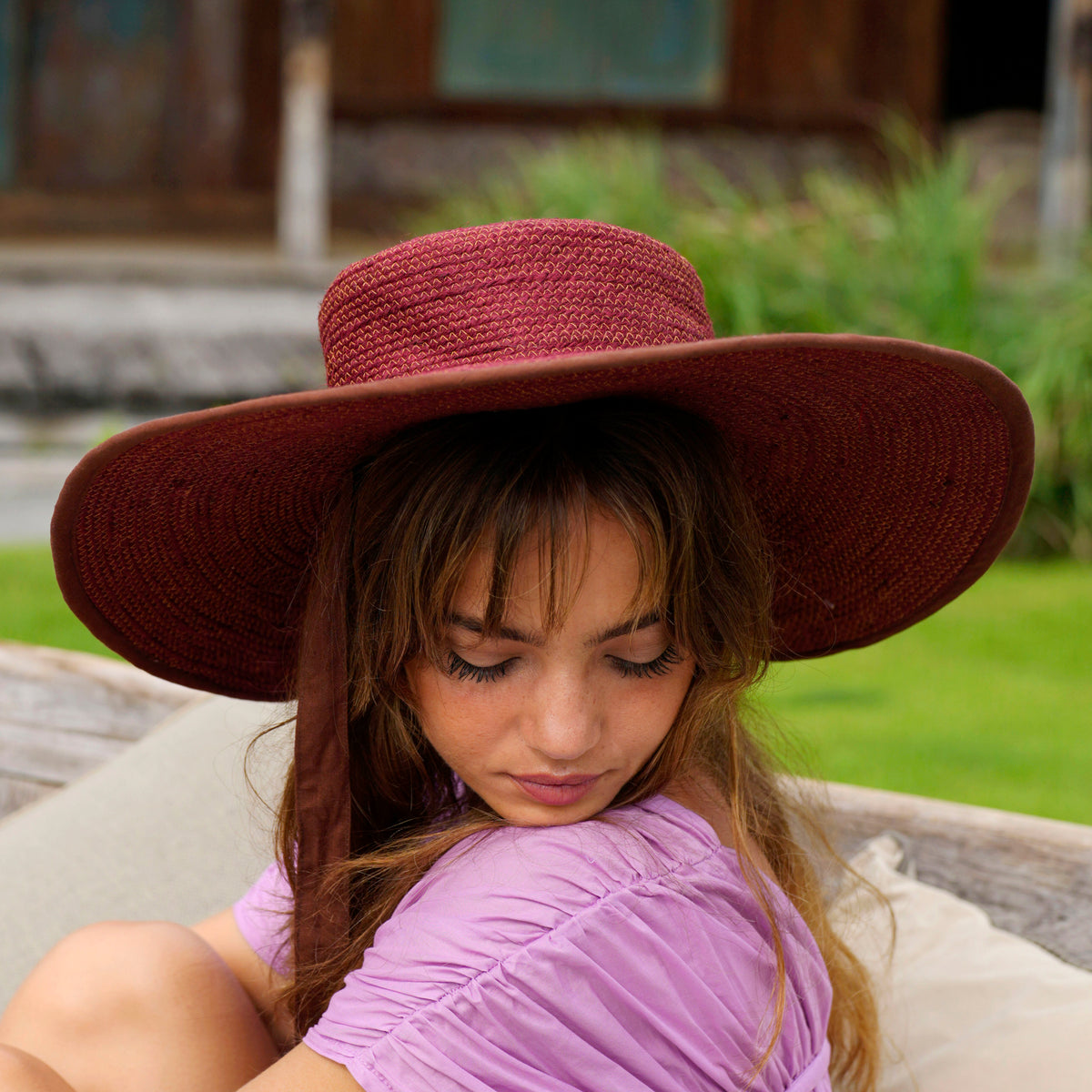 Inka Williams wears BrunnaCo's Burgundy Lolo Jute Hat in a Bali photoshoot. Handwoven by Balinese artisans, this piece beautifully combines sustainable craftsmanship with the effortless charm of California style.