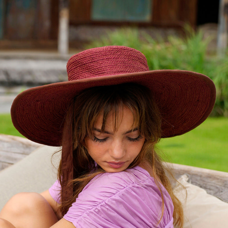 Inka Williams wears BrunnaCo's Burgundy Lolo Jute Hat in a Bali photoshoot. Handwoven by Balinese artisans, this piece beautifully combines sustainable craftsmanship with the effortless charm of California style.