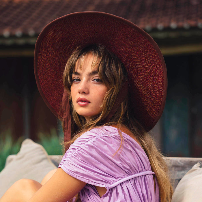 Inka Williams wears BrunnaCo's Burgundy Lolo Jute Hat in a Bali photoshoot. Handwoven by Balinese artisans, this piece beautifully combines sustainable craftsmanship with the effortless charm of California style.