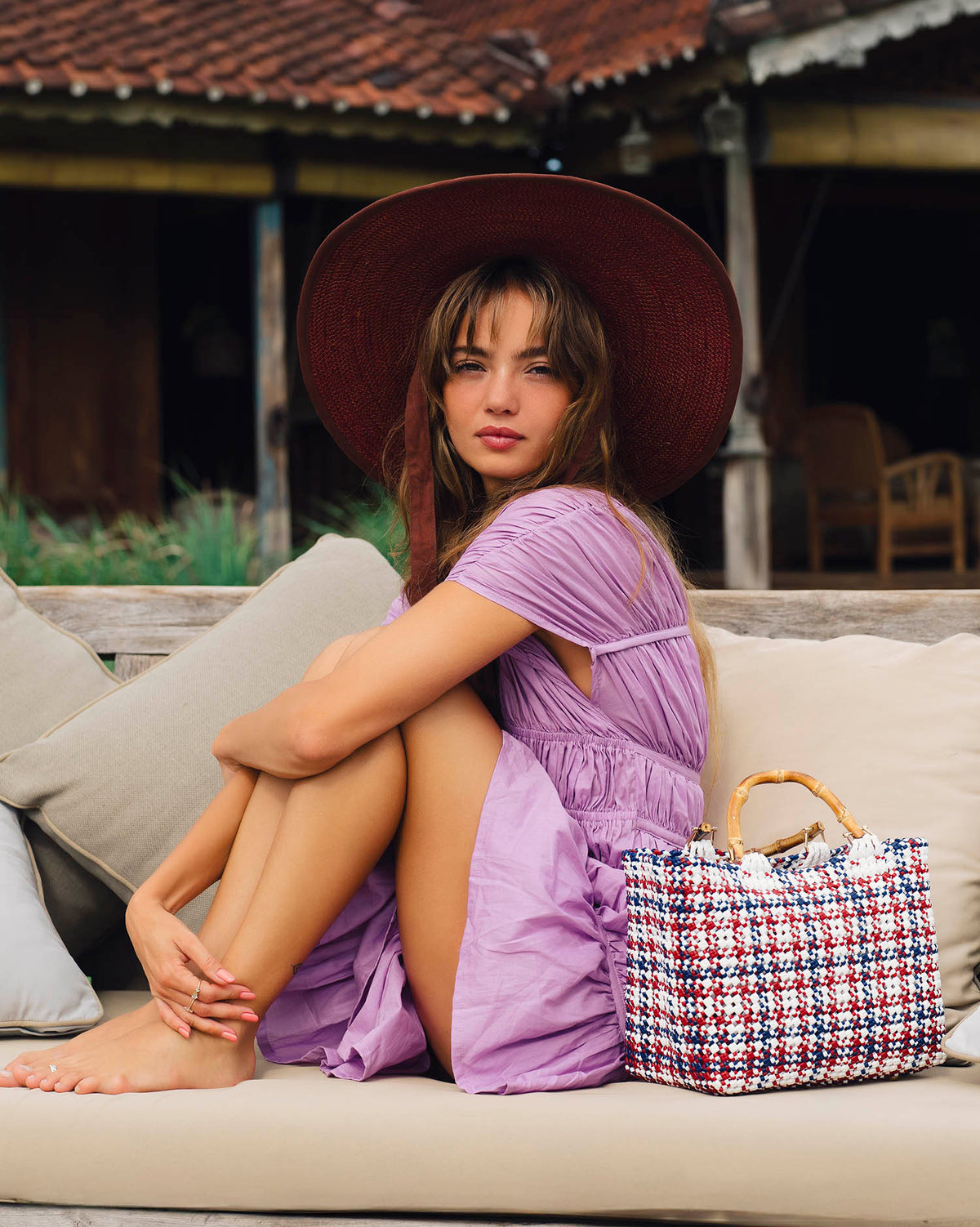 Inka Williams wears BrunnaCo's Burgundy Lolo Jute Hat in a Bali photoshoot. Handwoven by Balinese artisans, this piece beautifully combines sustainable craftsmanship with the effortless charm of California style.