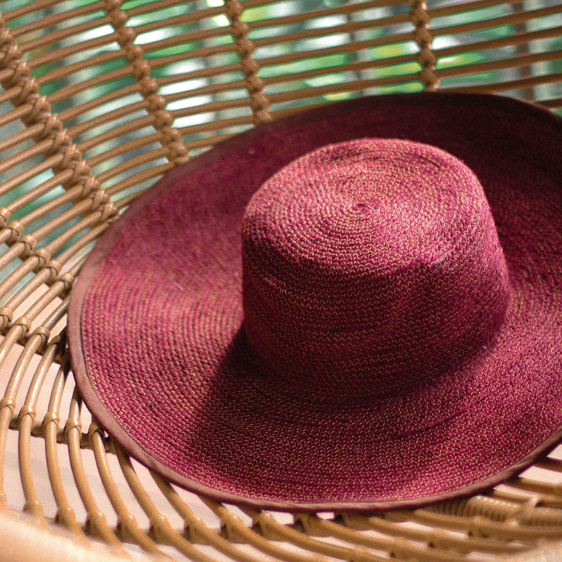 Inka Williams wears BrunnaCo's Burgundy Lolo Jute Hat in a Bali photoshoot. Handwoven by Balinese artisans, this piece beautifully combines sustainable craftsmanship with the effortless charm of California style.