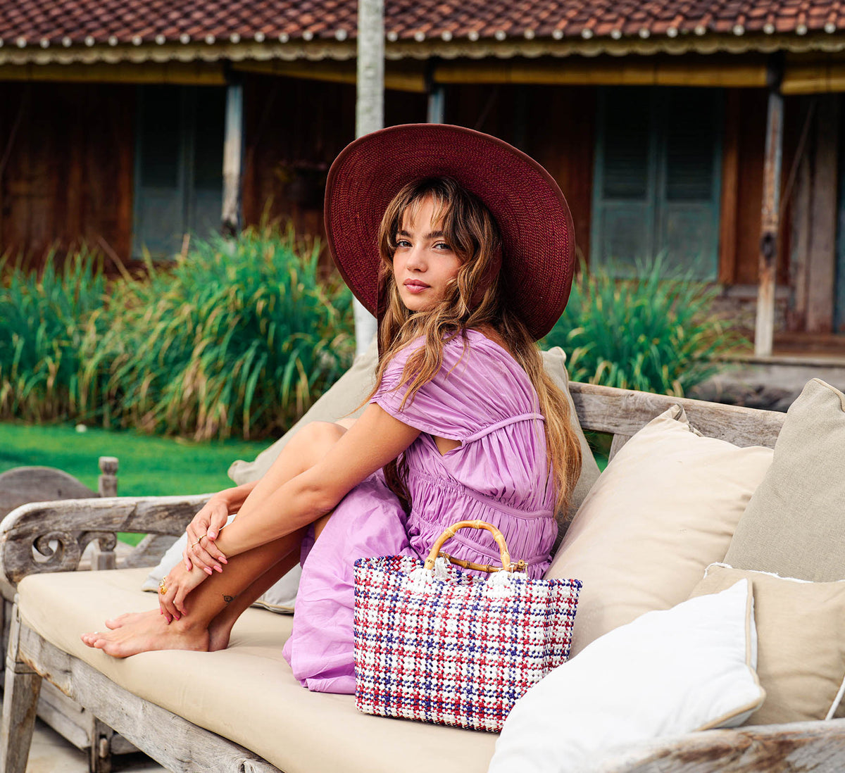 Inka Williams wears BrunnaCo's Burgundy Lolo Jute Hat in a Bali photoshoot. Handwoven by Balinese artisans, this piece beautifully combines sustainable craftsmanship with the effortless charm of California style.