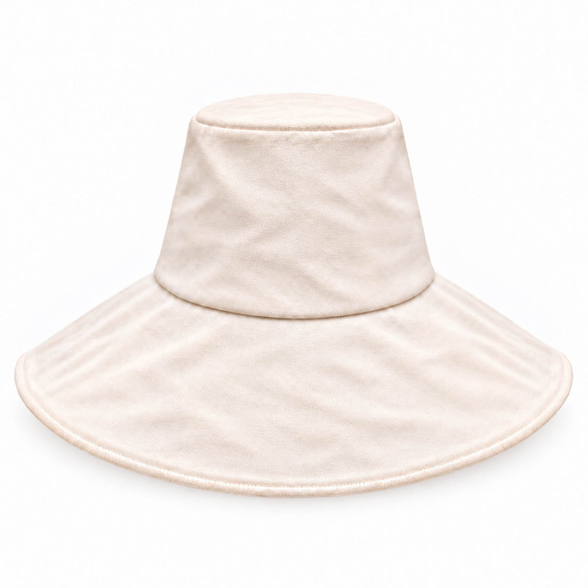 A light cream-colored wide-brim packable canvas sun hat with a soft, plush texture, shown against a plain white background.