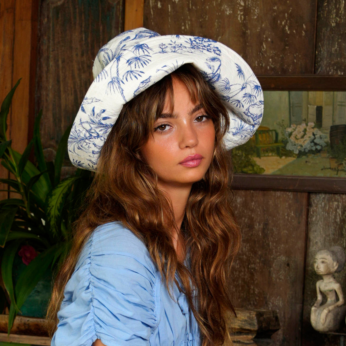 Inka Williams wears BrunnaCo's Nau Botanica Hat in a Bali photoshoot. Handcrafted from upcycled deadstock cotton, this hat merges sustainable craftsmanship with effortless California flair. The adorable princess blue color is a nod to Meghan Markle's As Ever dress, a great way to start spring season.
