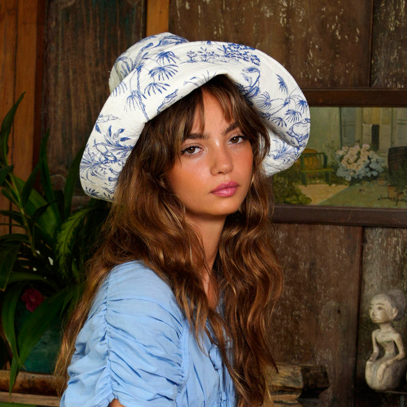 Inka Williams wears BrunnaCo's Nau Botanica Hat in a Bali photoshoot. Handcrafted from upcycled deadstock cotton, this hat merges sustainable craftsmanship with effortless California flair. The adorable princess blue color is a nod to Meghan Markle's As Ever dress, a great way to start spring season.