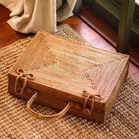 Inka Williams is holding BrunnaCo's Rahayu Atta Rattan Bag handmade in Bali using natural Atta rattan straws from Lombok. Inka is wearing BrunnaCo's Srikandi Ruffle Christmas dress in Sienna Brown. Designed in California.
