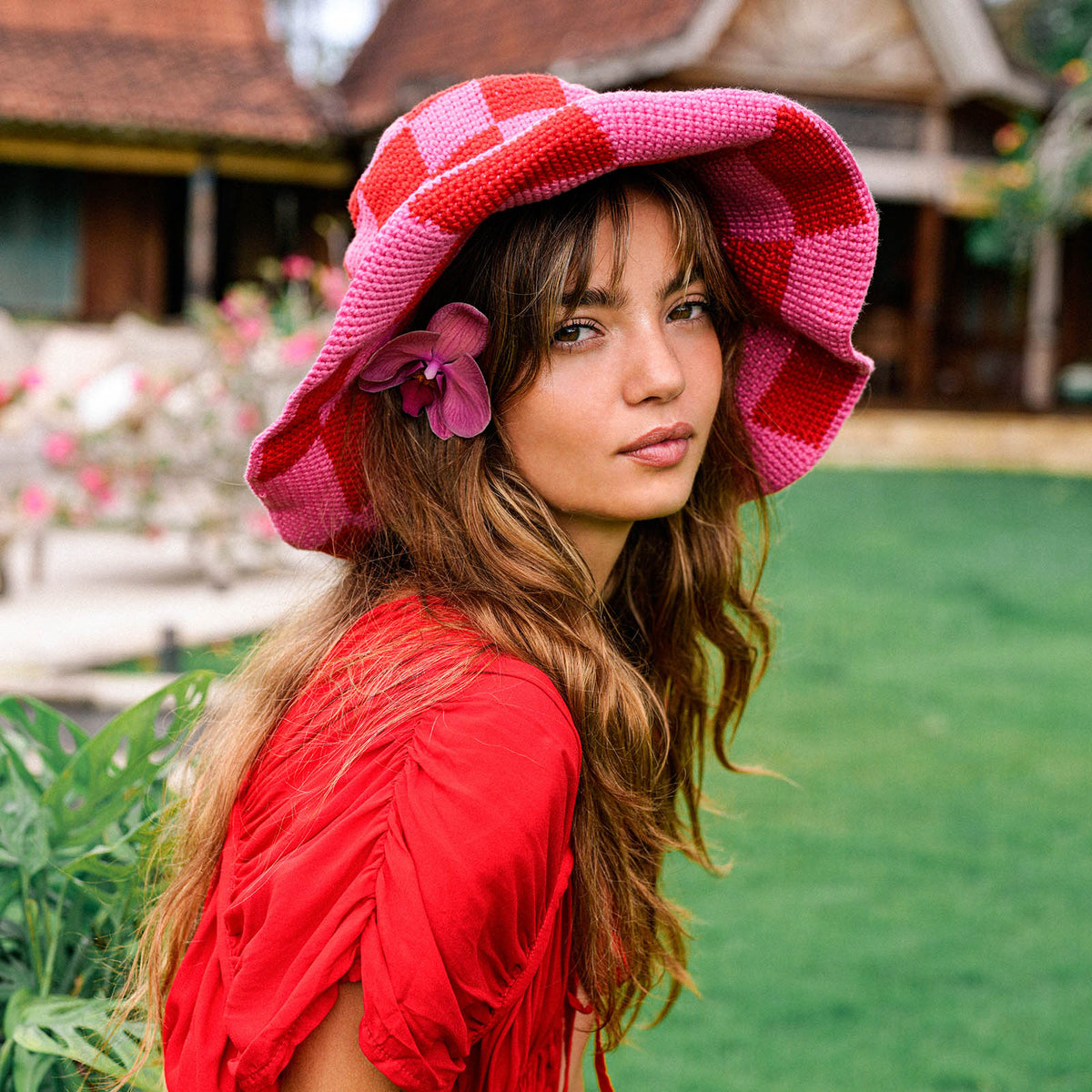 Inka Williams wears BrunnaCo's Shilo Crochet Checkered Hat in a Bali photoshoot. Handwoven by Balinese artisans, this piece seamlessly blends sustainable craftsmanship with laid-back California charm.