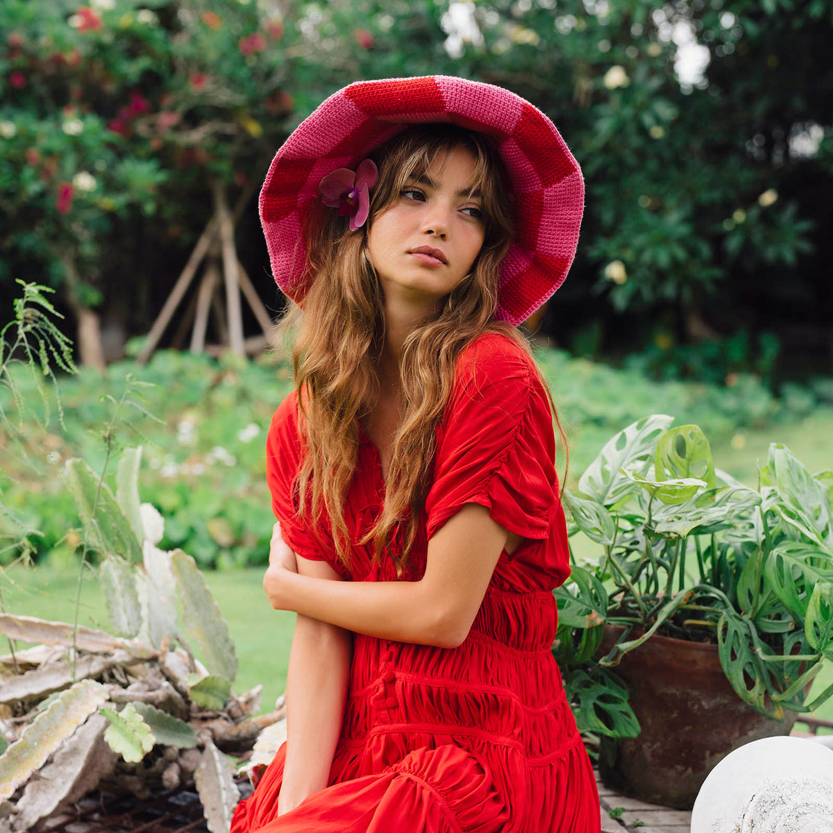 Inka Williams wears BrunnaCo's Shilo Crochet Checkered Hat in a Bali photoshoot. Handwoven by Balinese artisans, this piece seamlessly blends sustainable craftsmanship with laid-back California charm.