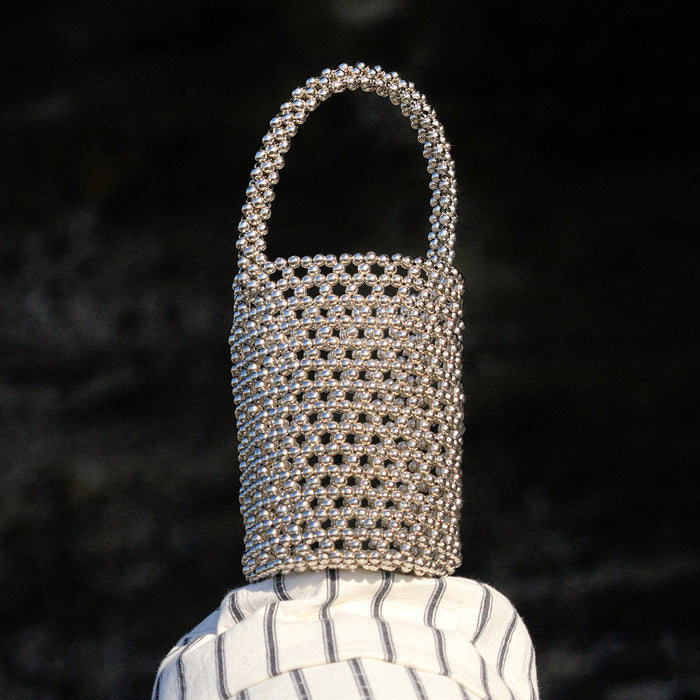 Introducing SILVA, the ultra-desirable bucket bag with the Bali X Cali-infused style. Feel nature’s energy in the palm of your hand as you tote the SILVA Metallic Beads Bucket bag on a sunny day at the beach.&nbsp;The shimmering metallic beads reflect the sunlight, creating a beautiful play of light and color.