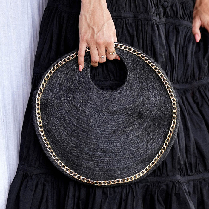 Inka Williams carries BrunnaCo's Black Solo Fig Jute Bag in small size, during a Bali photoshoot. Handwoven by Balinese artisans, this timeless piece embodies effortless California flair.