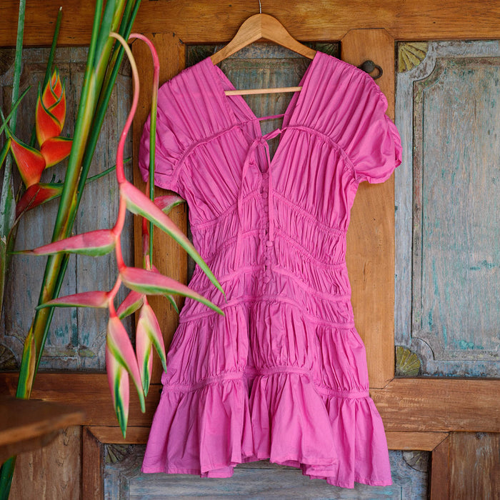 Inka Williams is wearing BrunnaCo's Srikandi Ruffle Dress in Pink Color, styled with Recycled Plastic TUKU Bag that are handmade by artisans in Bali, with a touch of Californian flair