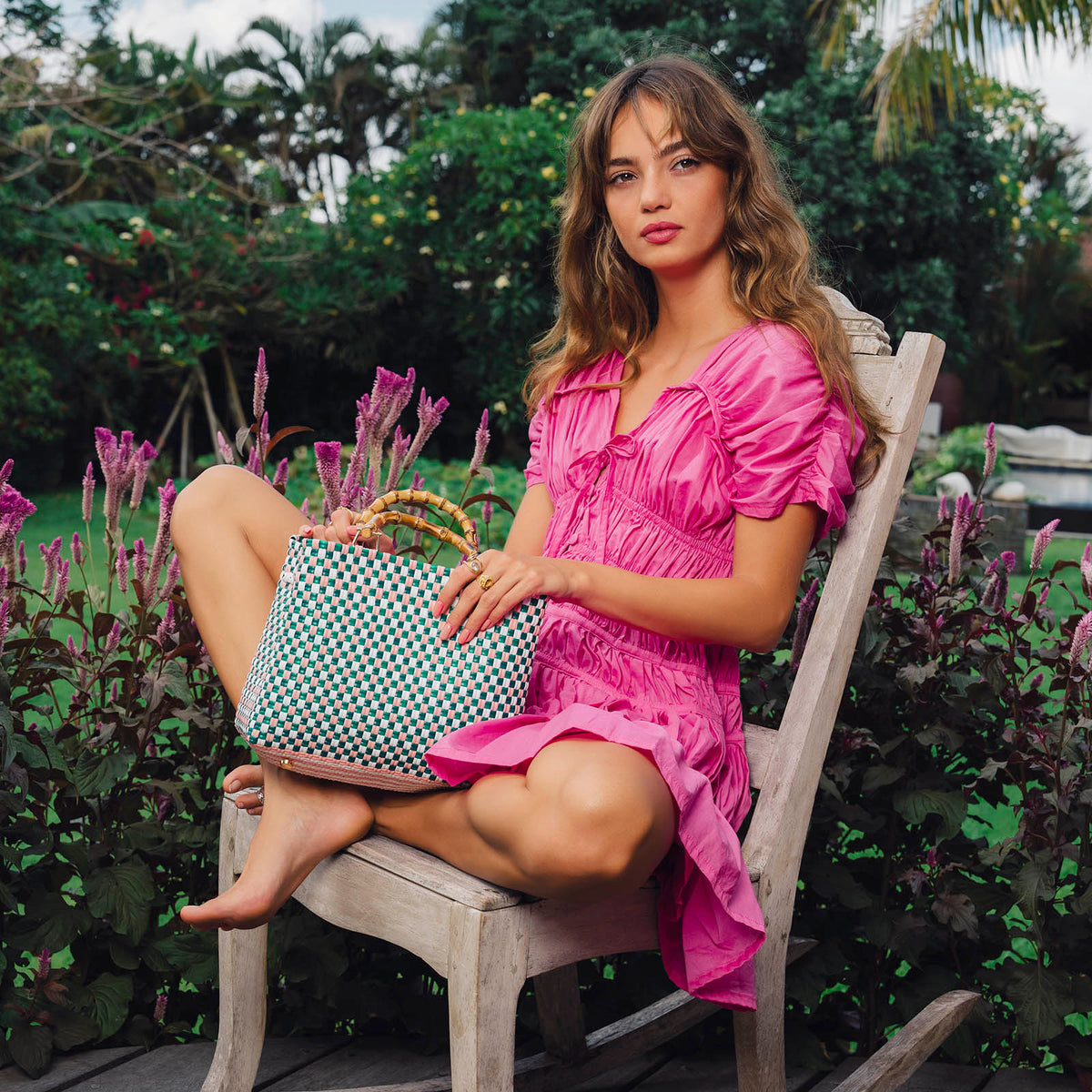 Inka Williams is wearing BrunnaCo's Srikandi Ruffle Dress in Pink Color, styled with Recycled Plastic TUKU Bag that are handmade by artisans in Bali, with a touch of Californian flair