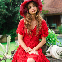 Inka Williams is wearing BrunnaCo's Red Srikandi Resort Ruffle Dress for a Bali photoshoot. Handmade by Balinese artisans, the dress blends traditional craftsmanship with effortless California flair.
