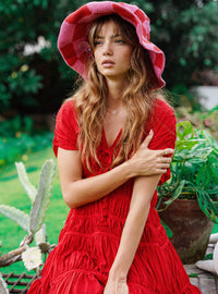 Inka Williams is wearing BrunnaCo's Red Srikandi Resort Ruffle Dress for a Bali photoshoot. Handmade by Balinese artisans, the dress blends traditional craftsmanship with effortless California flair.