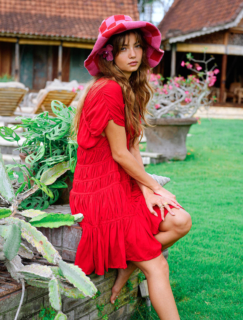 Inka Williams wears BrunnaCo's Red Srikandi Ruffle Dress for a Bali photoshoot. Handmade by Balinese artisans, the dress blends traditional craftsmanship with effortless California flair.