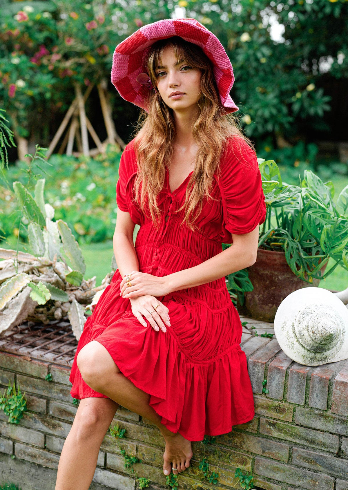 Inka Williams wears BrunnaCo's Red Srikandi Ruffle Dress for a Bali photoshoot. Handmade by Balinese artisans, the dress blends traditional craftsmanship with effortless California flair.