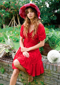 Inka Williams is wearing BrunnaCo's Red Srikandi Resort Ruffle Dress for a Bali photoshoot. Handmade by Balinese artisans, the dress blends traditional craftsmanship with effortless California flair.