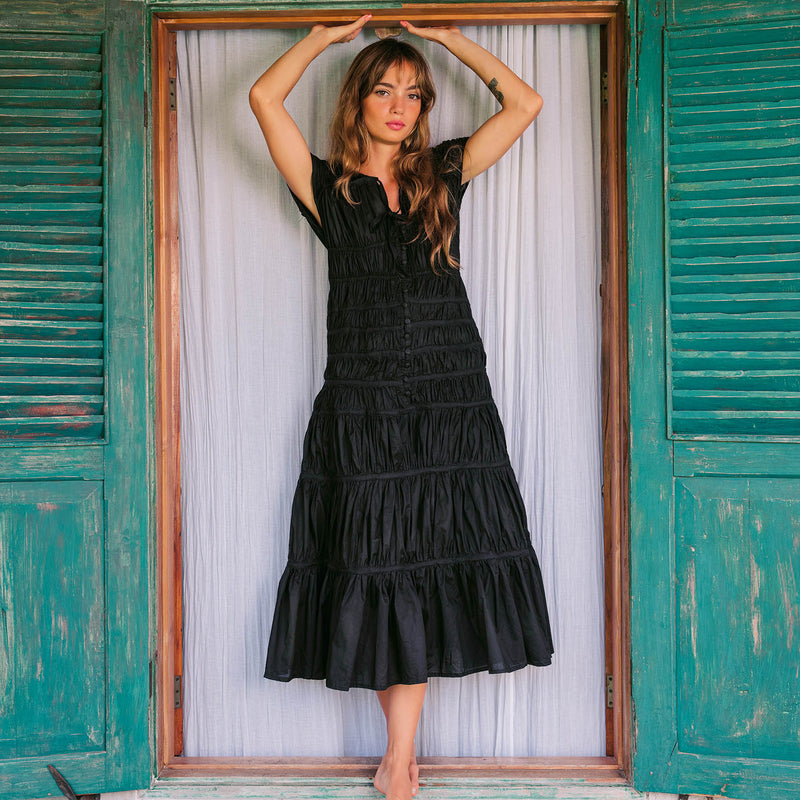 Inka Williams is wearing BrunnaCo's Black Srikandi Ruffle Dress styled with the Black Solo Jute Bag in a photoshoot in Bali. The dress is handmade by artisans in Bali, designed with Californian flair.