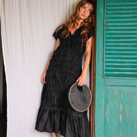 Inka Williams is wearing BrunnaCo's Black Srikandi Ruffle Dress styled with the Black Solo Jute Bag in a photoshoot in Bali. The dress is handmade by artisans in Bali, designed with Californian flair.