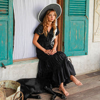 Inka Williams is wearing BrunnaCo's Black Srikandi Ruffle Dress styled with the Black Solo Jute Bag in a photoshoot in Bali. The dress is handmade by artisans in Bali, designed with Californian flair.