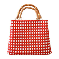 Inka Williams carries BrunnaCo's TUKU Recycled Plastic Market Tote, a handcrafted piece from Java and Bali made from repurposed plastic waste. Designed in California, it embodies the effortless charm of a California farmers' market.