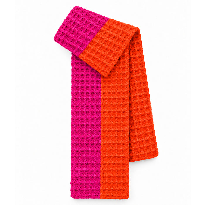 A textured waffle-knit scarf in vertical stripes of hot pink and bright orange, displayed on a clean white background.