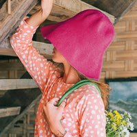 Bloom Crochet Cotton hat in Hot Barbie Pink. Soft and shapeable crochet hat inspired by the classic Calla Lily flower shape. Meticulously made by artisans in the villages of Bali. Its light and semi-floppy construction make it the perfect hat for picnics at the beach or any outdoor hike sessions any season of the year.
