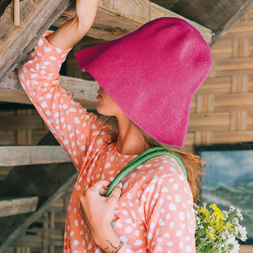 Bloom Crochet Cotton hat in Hot Barbie Pink. Soft and shapeable crochet hat inspired by the classic Calla Lily flower shape. Meticulously made by artisans in the villages of Bali. Its light and semi-floppy construction make it the perfect hat for picnics at the beach or any outdoor hike sessions any season of the year.