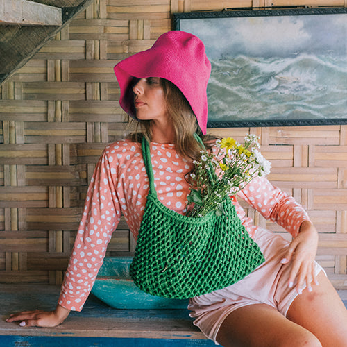 Bloom Crochet Cotton hat in Hot Barbie Pink. Soft and shapeable crochet hat inspired by the classic Calla Lily flower shape. Meticulously made by artisans in the villages of Bali. Its light and semi-floppy construction make it the perfect hat for picnics at the beach or any outdoor hike sessions any season of the year.