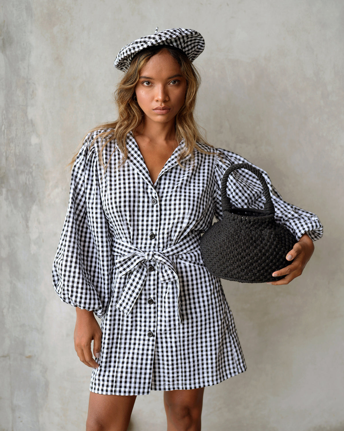 BrunnaCo Meghan Mini Gingham Dress in Black - A stylish and versatile dress made from 100% cotton. This dress features a sweet silhouette with voluminous medium-length puff sleeves, a chic short skirt with bow-detailing, and a removable waist belt. The Meghan Mini Gingham Dress is perfect for any occasion, from a casual picnic to a formal event.