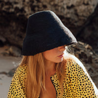 Naomi Jute Bucket Hat in black is designed specifically for the wild at heart with classic sophistication. Enjoy lounging poolside or exploring the city on sun-soaked days as its protective hat brim provides ample shade. Made of natural jute straws which have the perfect weight, this hat will sit comfortably and won't fly away in sudden gusts. It's also very practical to pack in any size luggages and ideal to take on any trips.
