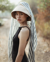 Naomi Jute Straw hat in Beige. Naomi Jute Bucket Hat is designed specifically for the wild at heart with classic sophistication. Enjoy lounging poolside or exploring the city on sun-soaked days as its protective hat brim provides ample shade. Made of natural jute straws which have the perfect weight, this hat will sit comfortably and won't fly away in sudden gusts. It's also very practical to pack in any size luggages and ideal to take on any trips.