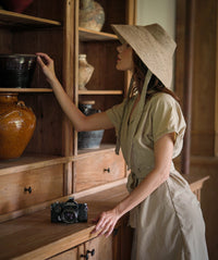 Reign Jute Straw Hat in Nude Beige. REIGN is a classic multi-functional hat with downturned brim made with natural jute straw and a modern structural shape. This hat is made to accompany you from the great outdoors to chic dinner and anywhere you travel in between.