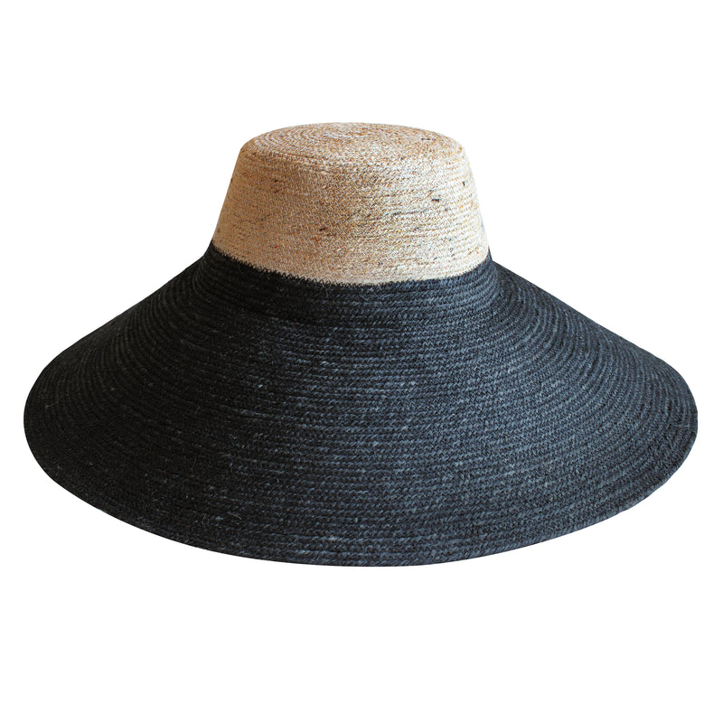 Duo color tone handwoven beach straw hat in natural and black brim color, handmade from natural jute straw by local artisan in Bali. Handmade vacation wide-brim hat with domed down brim for maximum sun protection. Sustainably made by female artisan community in Indonesia for resort vacation season.
