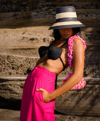 Taylor pants in hot barbie pink are a classic piece, made for a perfect day under the warm sun. Made with comfy and light-weight cotton fabric, these pleated pants have a high rise and slim fit along the waist with a wide-leg silhouette. Wear yours with BrunnaCo’s rope bralette or a cropped top.