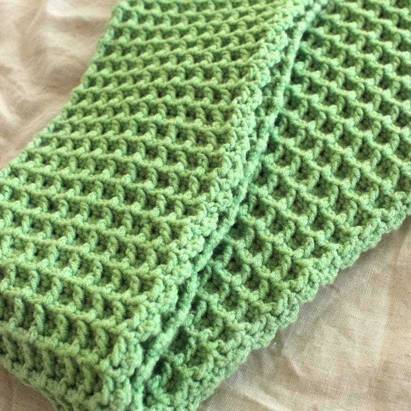 BrunnaCo's WAFFLE Crochet Scarf in sage green has a cozy and buttery-soft texture that makes you want to wear it everywhere when the temperature gets cold. It's hand-crocheted in waffle pattern with sumptuous cotton yarn by our female artisans in Java who put so much love into this piece. Wrap it around your neck twice or let it drape loosely over the lapels of your coat.