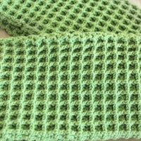 BrunnaCo's WAFFLE Crochet Scarf in sage green has a cozy and buttery-soft texture that makes you want to wear it everywhere when the temperature gets cold. It's hand-crocheted in waffle pattern with sumptuous cotton yarn by our female artisans in Java who put so much love into this piece. Wrap it around your neck twice or let it drape loosely over the lapels of your coat.